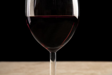 Wineglass filled with red wine.