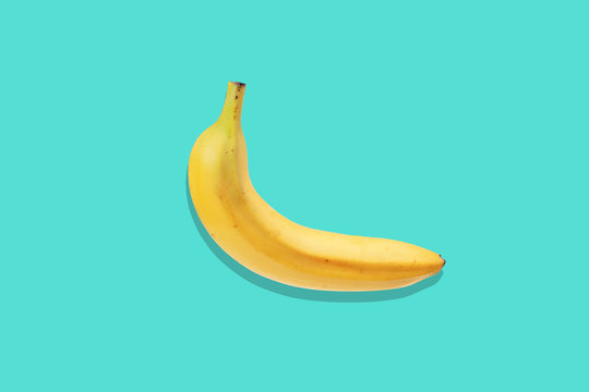 Fresh banana close up on bright blue background. Flat lay. Summer concept.