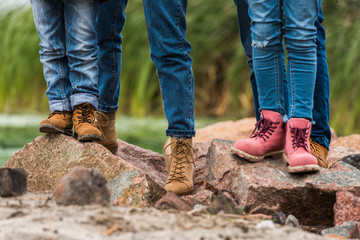 family standing on rocks