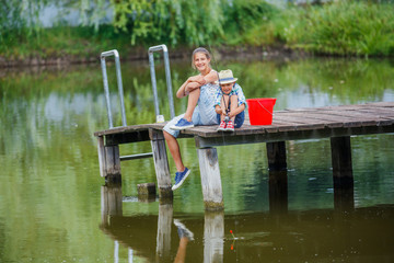 Lonely little child fishing on river