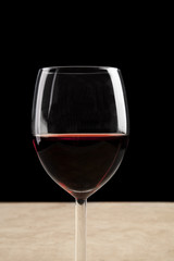 Wineglass filled with red wine.
