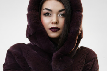 Portrait of Young stylish Woman in Luxury Fur Coat