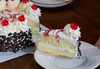 Birthday cake cut off devide put white dish for eat