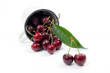 White cup with red sweet cherry isolated on a white background..