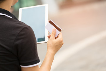 Close up of Man Hands holding credit card and using Tablet,Online shopping concept