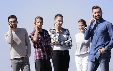 young people talking on their smartphones.