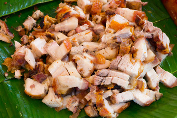 Close up Thai roasted crispy pork on banana leaf