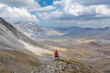 Fototapeta na wymiar Woman watching power of nature at Campo Imperatore plateau