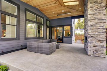 Fototapeta na wymiar New modern home features a backyard with patio