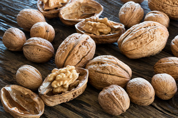 Whole and broken walnuts on old wood