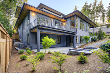 New modern home features a backyard with patio