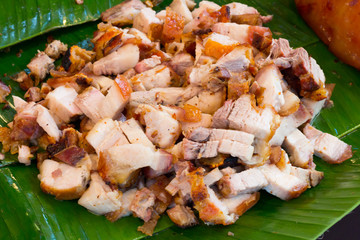 Close up Thai roasted crispy pork on banana leaf