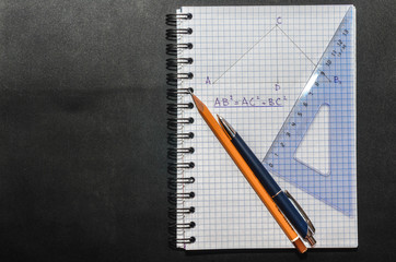 Page with formulas and the Pythagorean theorem with pen, pencil and ruler