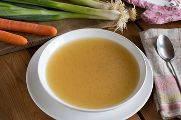 Bone broth made from chicken served in a white plate