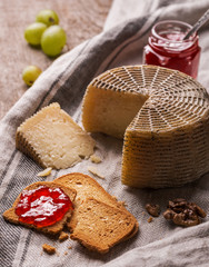 Still life with goat cheese, bread slices and jam