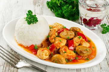 Chicken stew with mushrooms served  with rice
