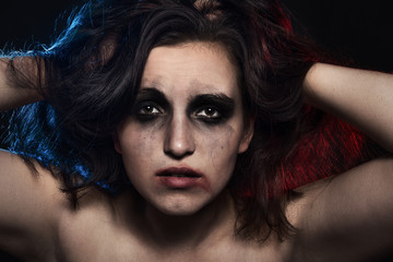 sad woman with smeared cosmetics on dark background