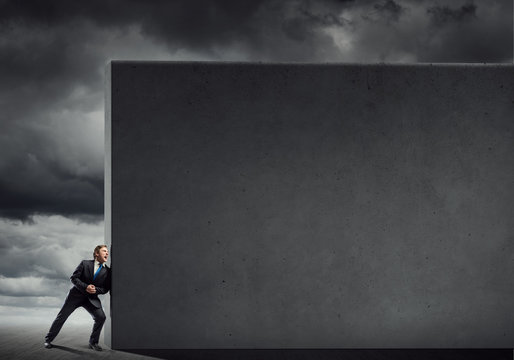 Businessman push wall