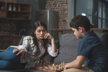 Mother and boy playing chess