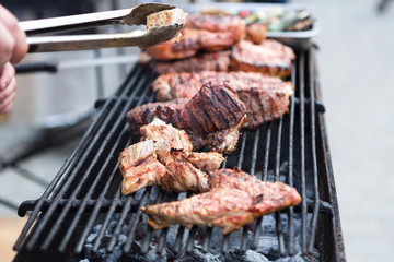 Pork ribs cooking on grill at bbq party