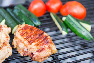 Pork fillet cooking on grill at bbq party