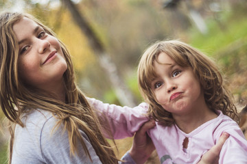 Young sisters playing together in the garden.