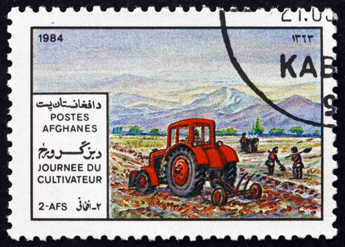 Postage stamp Afghanistan 1984 tractor plowing a field