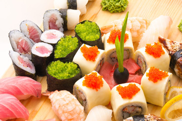 Sushi rolls served on a wooden plate in a restaurant