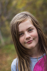 Young, blonde girl shy smiling. Close-up.