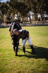 Man standing with horse in the ranch