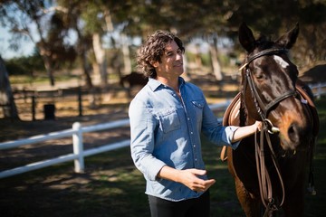 Man standing with horse in the ranch