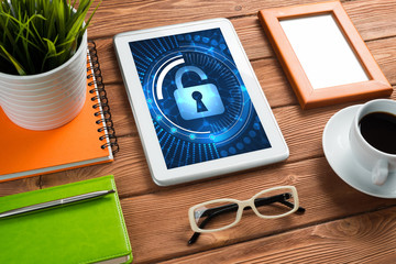 Web security and technology concept with tablet pc on wooden table