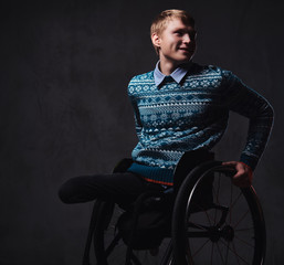 Obraz premium A man in wheelchair over grey background.