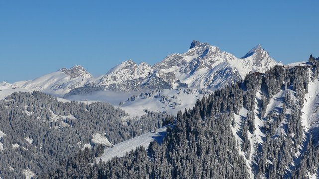 Distant view of the Wasserngrat ski area, Gstaad. Winter landscape in Switzerland.