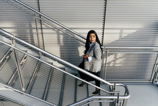 Elegant Woman Climbing Stairs On Street