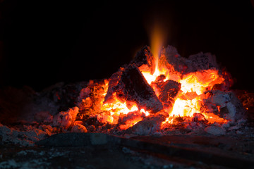 Fire flames of a bonfire in fireplace. Bonfire and coals close-up.