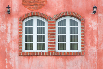 Fototapeta na wymiar Picturesque window on red wall of house. Italy home style