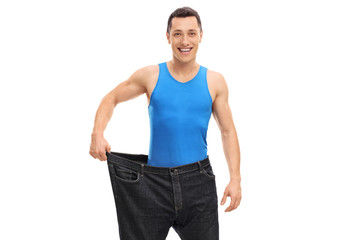 Fototapeta premium Young guy in a pair of oversized jeans