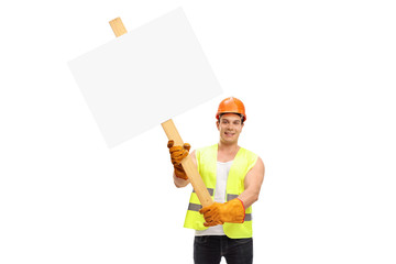 Construction worker holding a blank cardboard sign