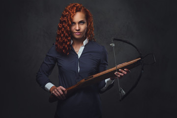 Redhead female  holds crossbow.