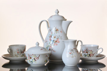 Old coffee set on a glass table.