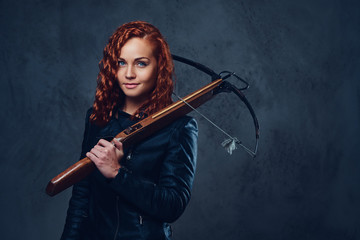 Fototapeta premium Redhead female holds crossbow.