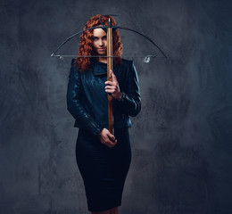 Redhead female  holds crossbow.