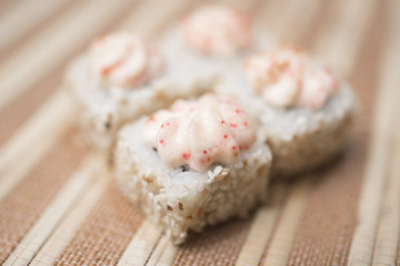 Sushi rolls with sesame and sauce close-up in defocus 3