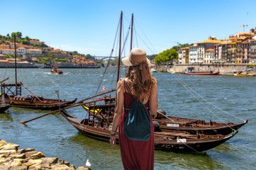 Yougn woman in red dress traveling in Portugal