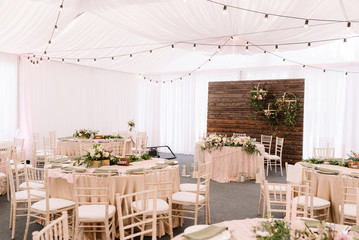 Wedding decorated restaurant in light colors and rustic style