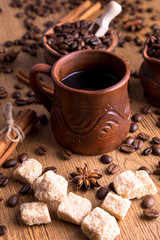 Fototapeta na wymiar grains of black coffee on the wooden table