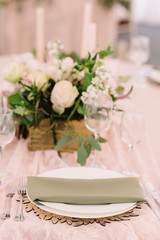 Plate with napkin front of floral box, portrait mode