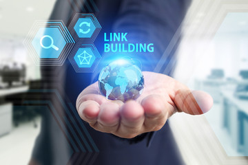 The concept of business, technology, the Internet and the network. A young entrepreneur working on a virtual screen of the future and sees the inscription: Link building