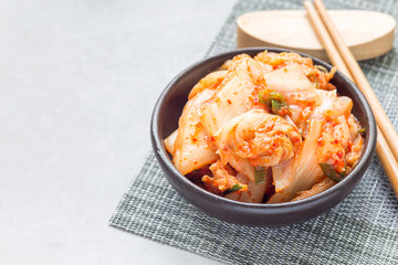 Kimchi cabbage. Korean appetizer in ceramic bowl, horizontal, copy space